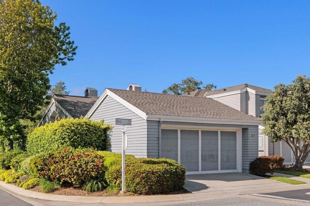 814 Okra Ct, Carlsbad, CA 92011 - view of property exterior featuring a garage, a chimney, concrete driveway, and roof with shingles