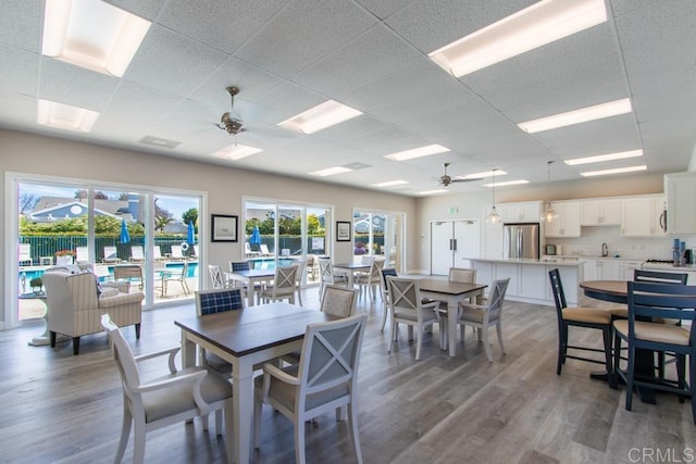 814 Okra Ct, Carlsbad, CA 92011 - dining room featuring ceiling fan, wood finished floors, and a drop ceiling