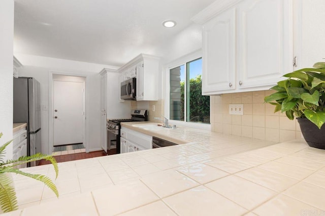 814 Okra Ct, Carlsbad, CA 92011 - kitchen with appliances with stainless steel finishes, white cabinets, backsplash, tile countertops, and recessed lighting