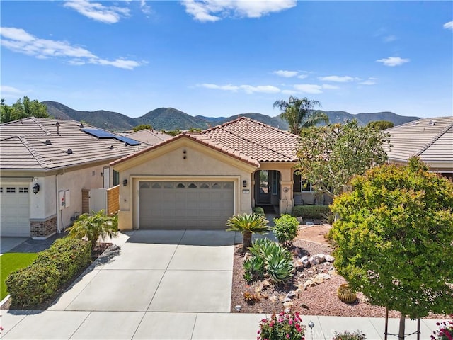 5551 Corte Fiesta, Hemet, CA 92545 - view of front of home with a mountain view, stucco siding, a tiled roof, an attached garage, and driveway