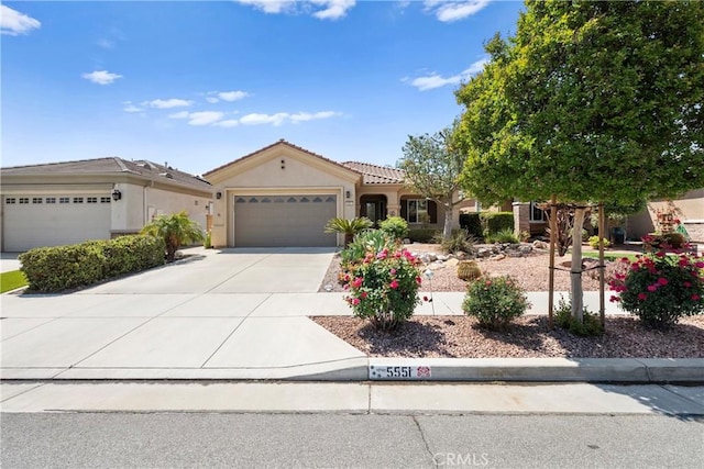 5551 Corte Fiesta, Hemet, CA 92545 - mediterranean / spanish home featuring a garage, concrete driveway, stucco siding, and a tile roof
