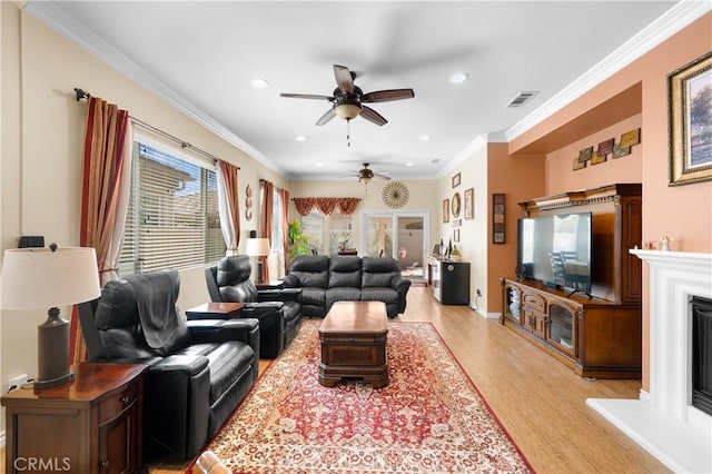 5551 Corte Fiesta, Hemet, CA 92545 - living area with a ceiling fan, light wood-style floors, recessed lighting, a fireplace with raised hearth, and ornamental molding