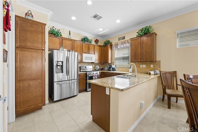 5551 Corte Fiesta, Hemet, CA 92545 - kitchen with appliances with stainless steel finishes, a peninsula, brown cabinets, tasteful backsplash, and recessed lighting