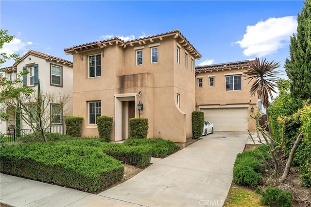 2677 E Tyler St, Long Beach, CA 90810 - mediterranean / spanish house featuring concrete driveway, an attached garage, a tile roof, and stucco siding