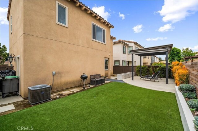 2677 E Tyler St, Long Beach, CA 90810 - back of property featuring cooling unit, a patio, a fenced backyard, stucco siding, and a yard