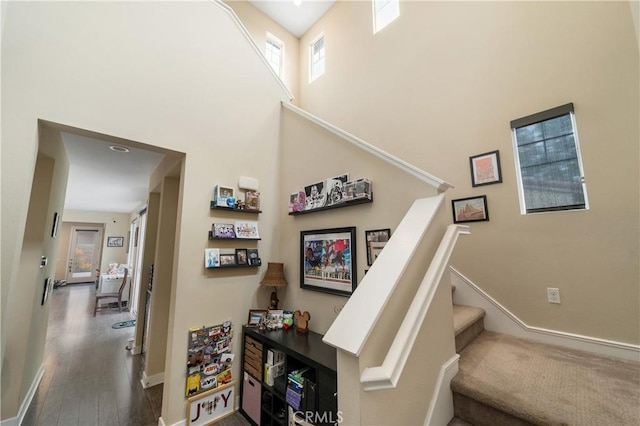 2677 E Tyler St, Long Beach, CA 90810 - stairs featuring baseboards, a towering ceiling, and wood finished floors