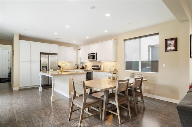 2677 E Tyler St, Long Beach, CA 90810 - dining area featuring dark wood-style flooring, baseboards, and recessed lighting