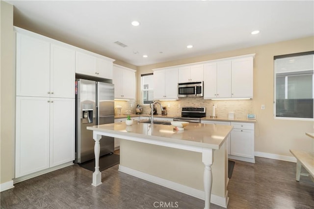 2677 E Tyler St, Long Beach, CA 90810 - kitchen with a sink, an island with sink, backsplash, and stainless steel appliances