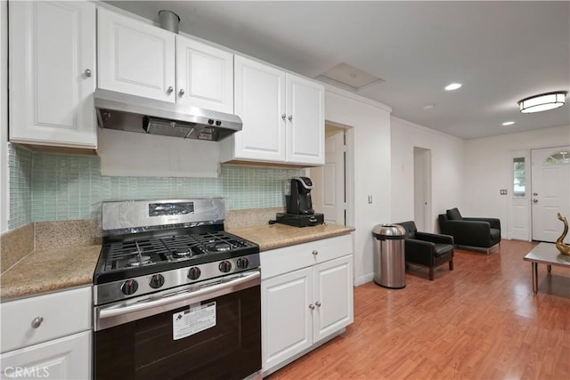 2989 W 12th St, Los Angeles, CA 90006 - kitchen featuring stainless steel range with gas stovetop, under cabinet range hood, light wood finished floors, light countertops, and white cabinets