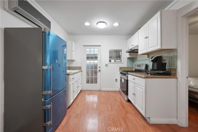 2989 W 12th St, Los Angeles, CA 90006 - kitchen featuring gas stove, freestanding refrigerator, light wood-style floors, white cabinetry, and under cabinet range hood
