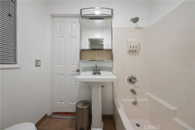 2989 W 12th St, Los Angeles, CA 90006 - bathroom with bathing tub / shower combination, tile patterned floors, toilet, baseboards, and a sink