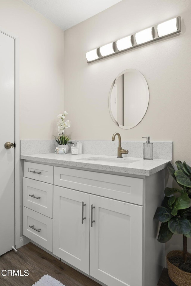 bathroom featuring vanity and wood finished floors
