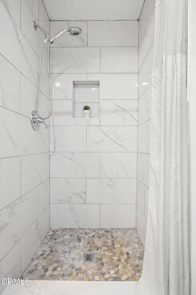 full bathroom with a tile shower