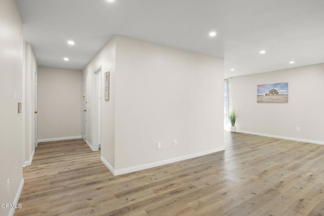 spare room with recessed lighting, baseboards, and light wood-style floors