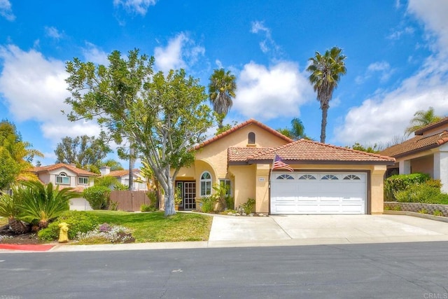 mediterranean / spanish home featuring a tiled roof, an attached garage, driveway, and stucco siding