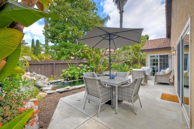 view of patio / terrace with a fenced backyard and outdoor dining space