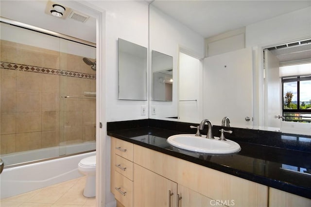 full bathroom with visible vents, tile patterned flooring, vanity, toilet, and enclosed tub / shower combo