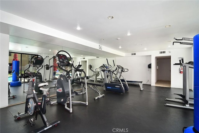 gym featuring recessed lighting and visible vents