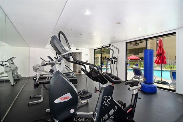 exercise room featuring recessed lighting and a wall of windows