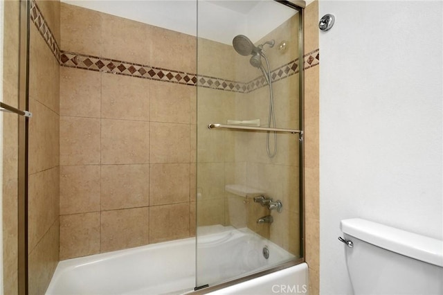full bath featuring enclosed tub / shower combo and toilet