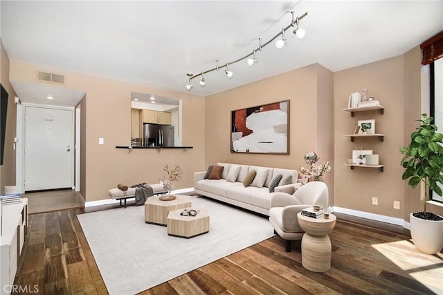 living room featuring visible vents, dark wood finished floors, and baseboards