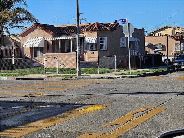 159 E 105th St, Los Angeles, CA 90003 - view of building exterior with a fenced front yard and a residential view