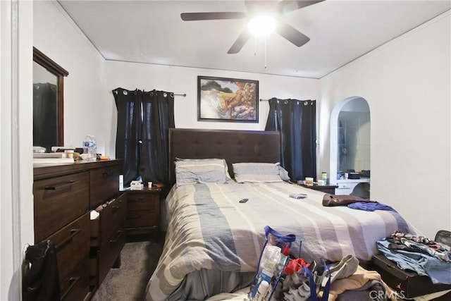 159 E 105th St, Los Angeles, CA 90003 - carpeted bedroom with arched walkways and a ceiling fan