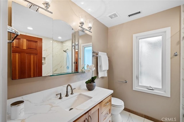 bathroom with a shower, vanity, toilet, and baseboards