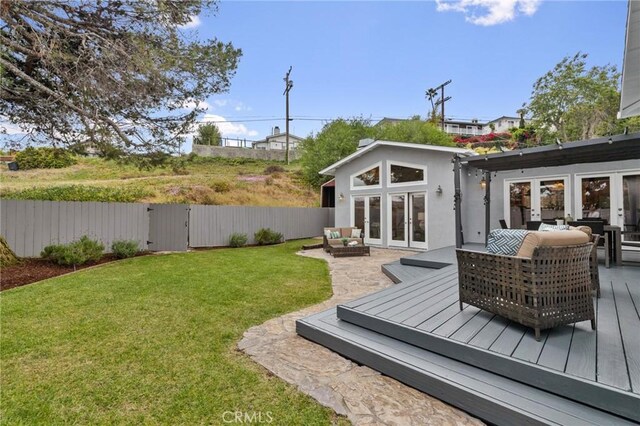 view of yard with french doors, a deck, an outdoor hangout area, and a gate
