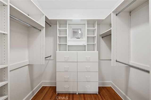 walk in closet with dark wood-type flooring