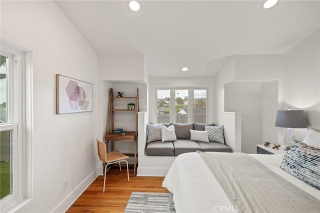bedroom with light wood-type flooring, recessed lighting, and baseboards