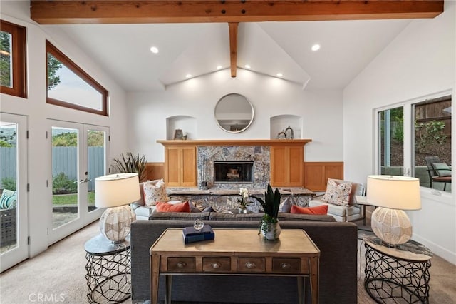 living room featuring light colored carpet, beamed ceiling, recessed lighting, a fireplace with raised hearth, and high vaulted ceiling