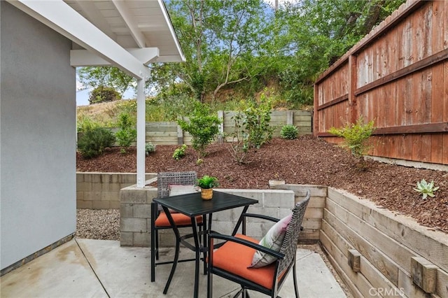view of patio with outdoor dining area and a fenced backyard