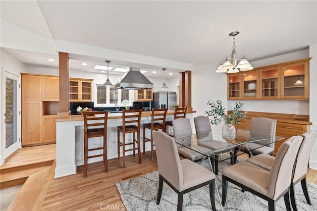 dining room featuring light wood finished floors, a chandelier, and recessed lighting