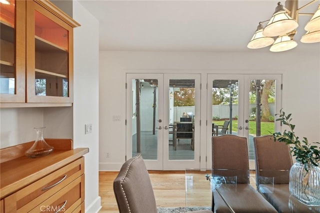 dining area featuring french doors and light wood-style flooring