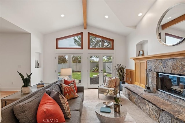 living room featuring a fireplace, french doors, a wainscoted wall, and recessed lighting