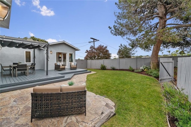 view of yard featuring an outdoor living space, a deck, outdoor dining area, and a gate