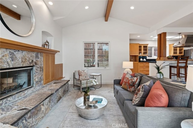 living room featuring light colored carpet, recessed lighting, and a stone fireplace