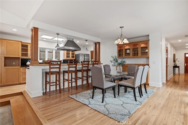dining space featuring recessed lighting, light wood finished floors, a chandelier, and baseboards