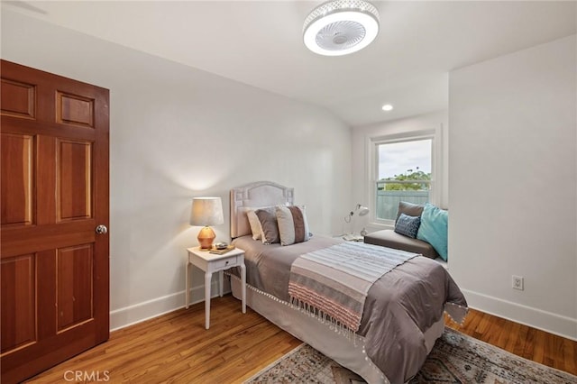 bedroom featuring baseboards, light wood-style flooring, and recessed lighting