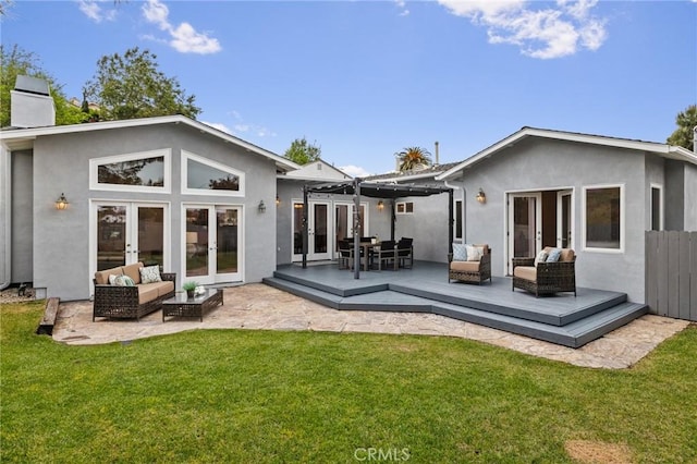 rear view of house with outdoor lounge area, a pergola, a wooden deck, and french doors