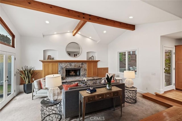 living area featuring recessed lighting, light carpet, french doors, and a glass covered fireplace