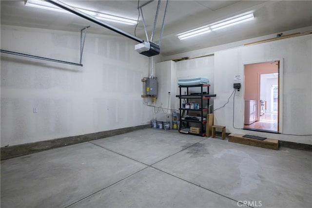 garage with a garage door opener and washer / clothes dryer
