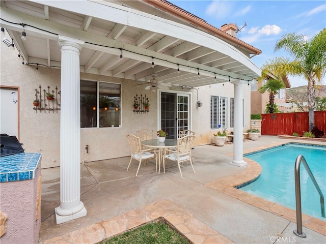 view of swimming pool featuring a fenced in pool, ceiling fan, a patio area, and fence