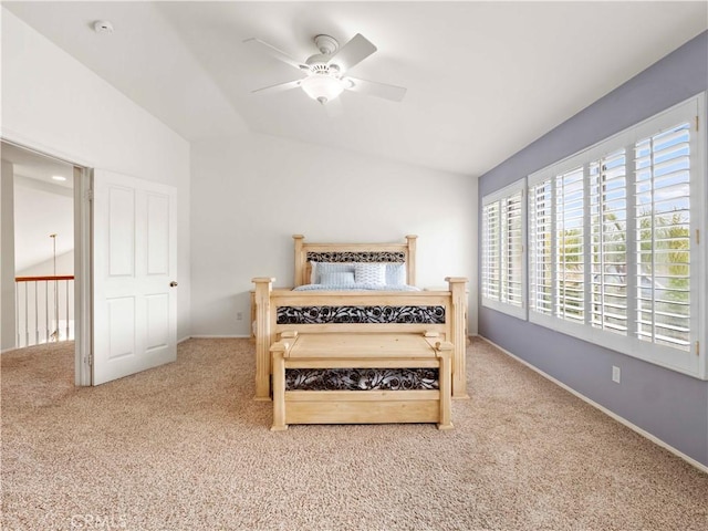carpeted bedroom featuring baseboards, a ceiling fan, and vaulted ceiling