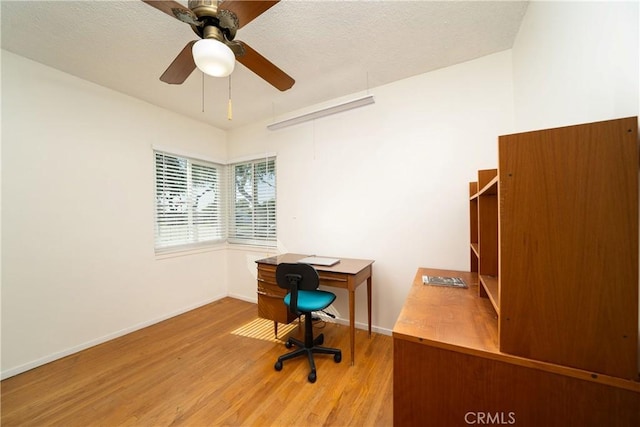 office with a ceiling fan, baseboards, and wood finished floors
