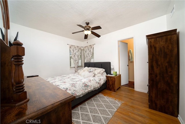 bedroom with baseboards, ceiling fan, and wood finished floors