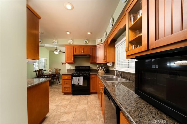 kitchen with brown cabinetry, a ceiling fan, recessed lighting, a sink, and black appliances