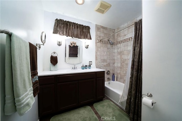 full bathroom with visible vents, shower / bath combo with shower curtain, and vanity