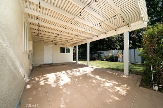 view of patio featuring a pergola, a fenced backyard, a shed, an attached carport, and an outbuilding